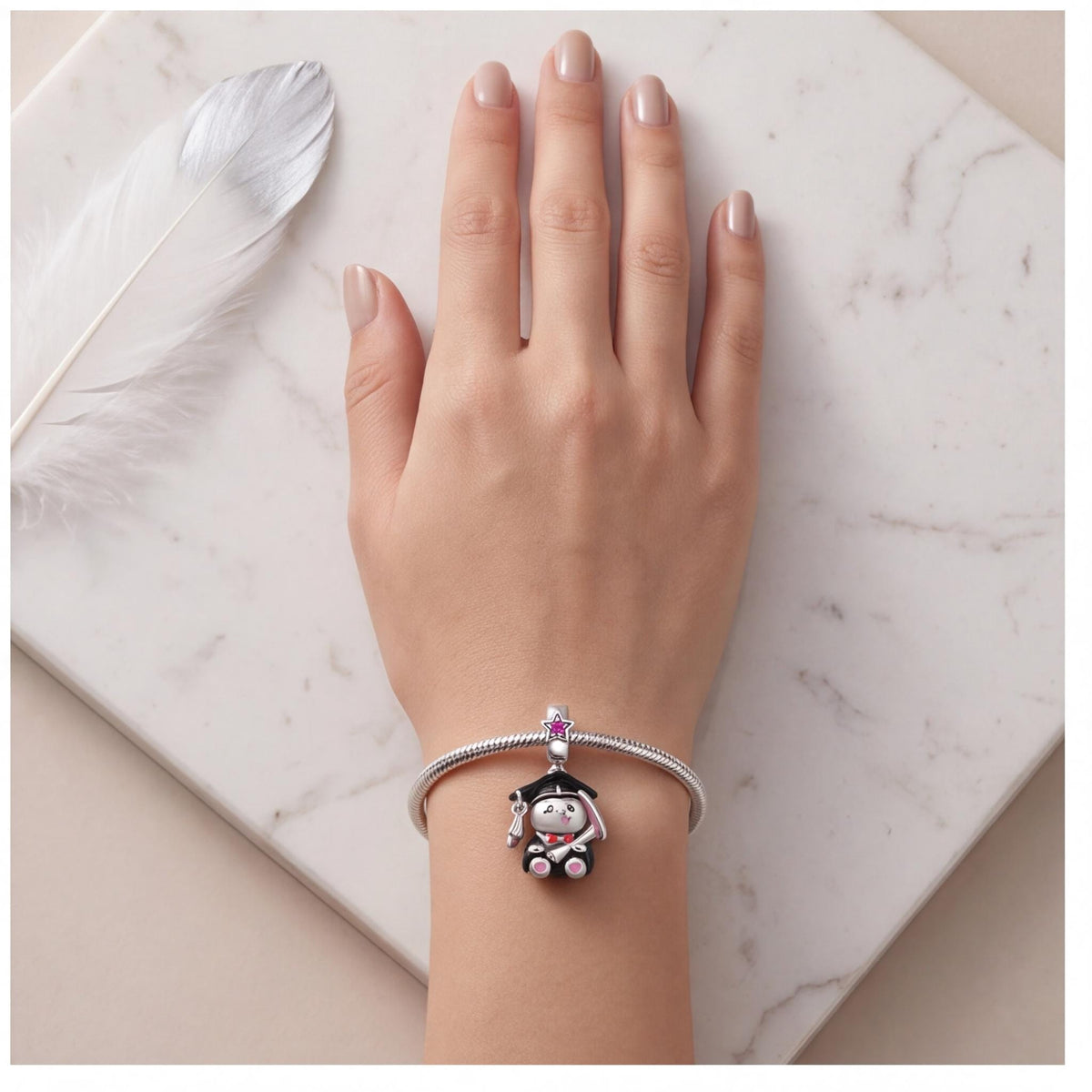 Graduation Bunny Dangle worn on a charm bracelet