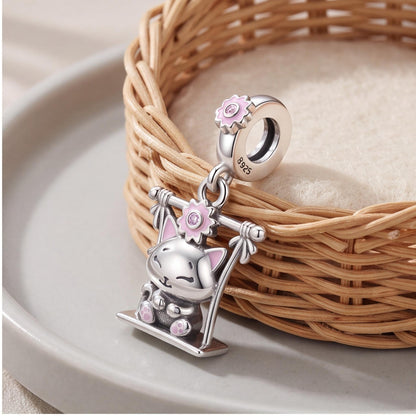 Swing Cat Dangle Charm on a silver charm bracelet