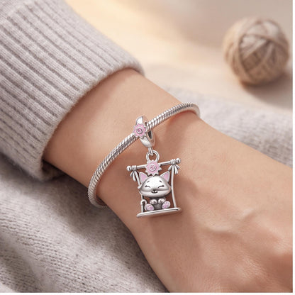 Swing Cat Dangle Charm close-up on a bracelet