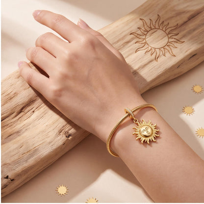 Sun Face Dangle Charm worn on a charm bracelet