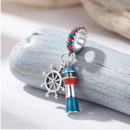 Lighthouse Ship Wheel Dangle on a silver charm bracelet