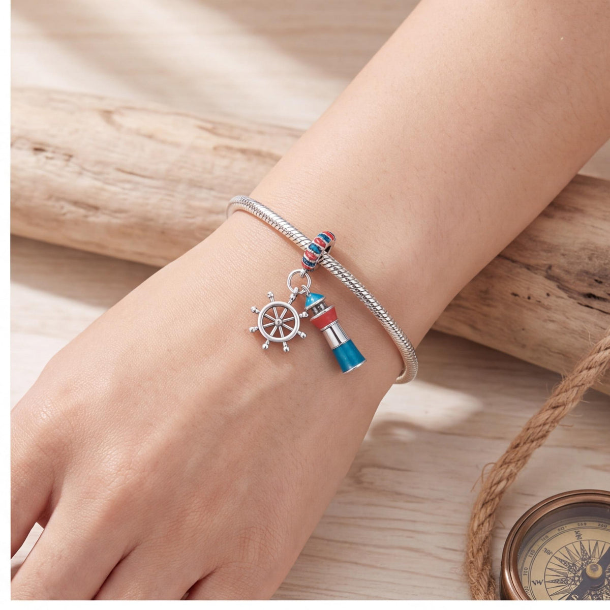 Lighthouse Ship Wheel Dangle worn on a charm bracelet