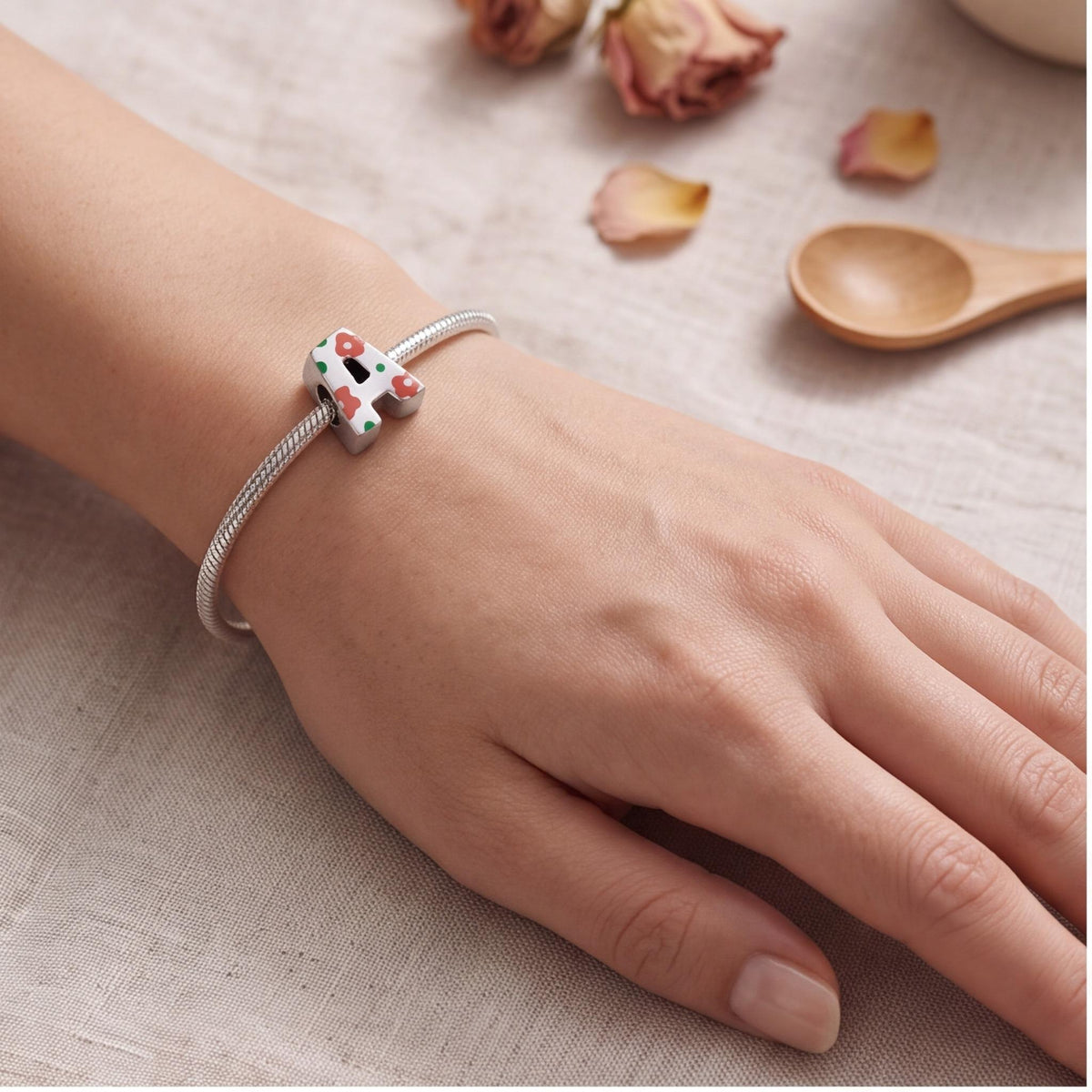 Floral Letter A Charm worn on a charm bracelet